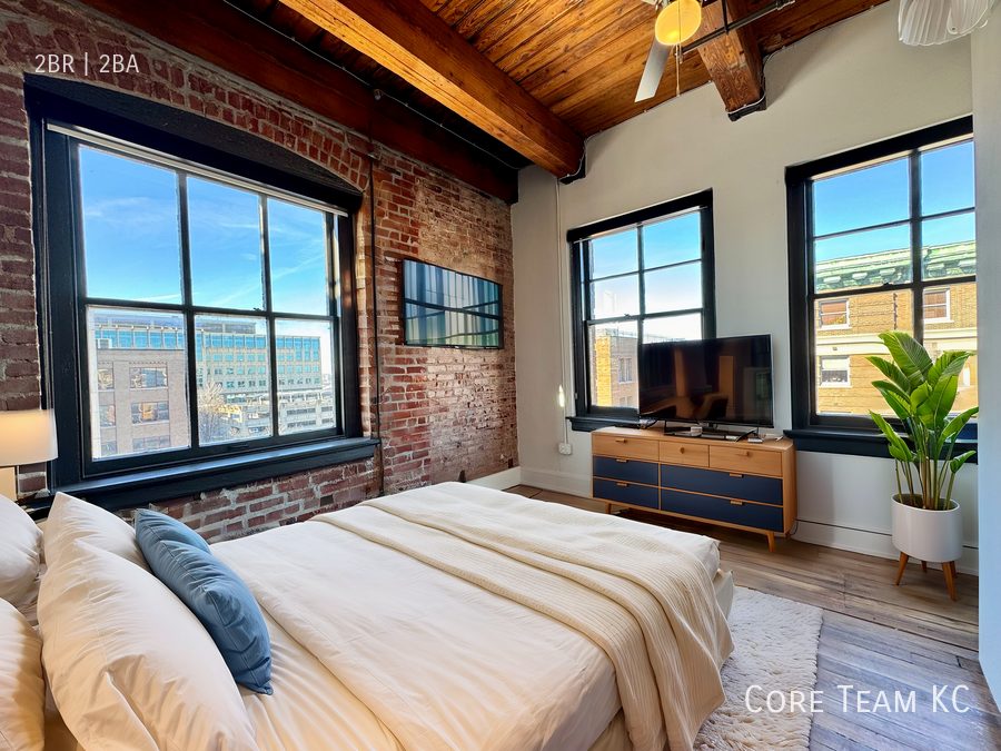 A finished two-bedroom loft at Harvey Dutton with exposed brick and heavy timber